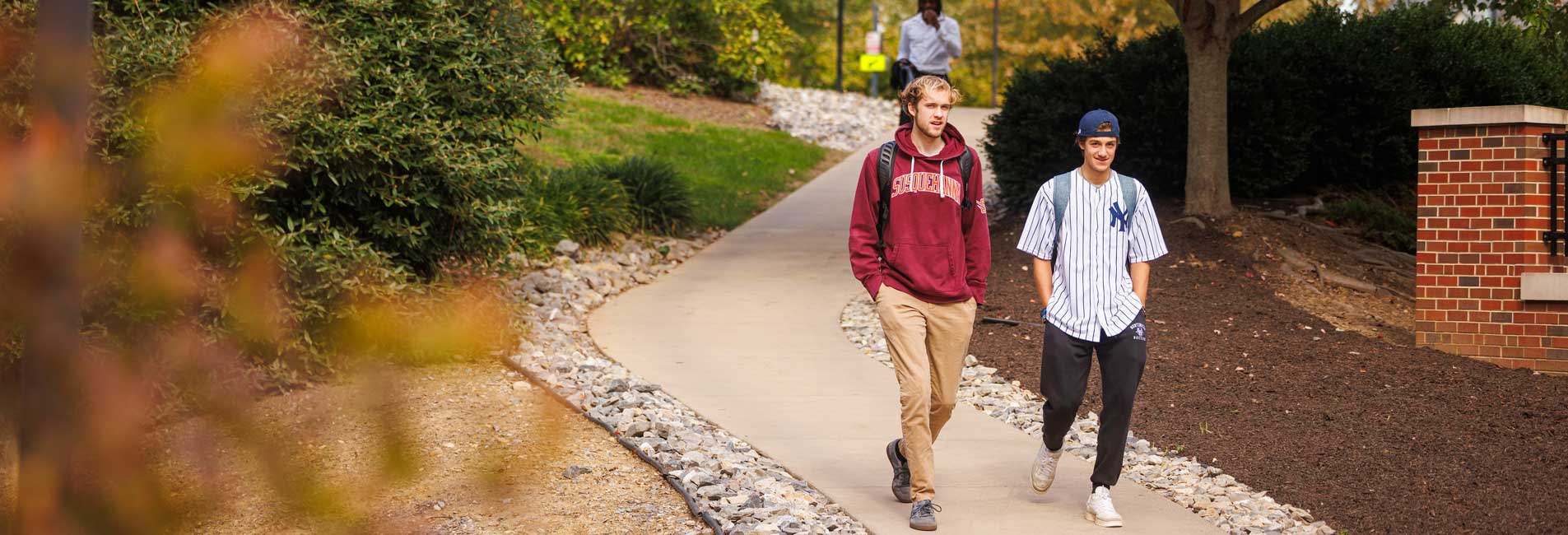 students walking on campus in the fall